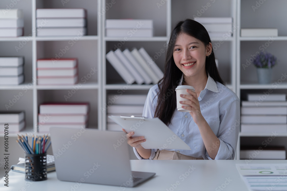 Young Asian woman working with a laptop and smartphone. Freelancer Businesswoman at work. Young Asian woman working with a laptop and smartphone. Freelancer Businesswoman at work.