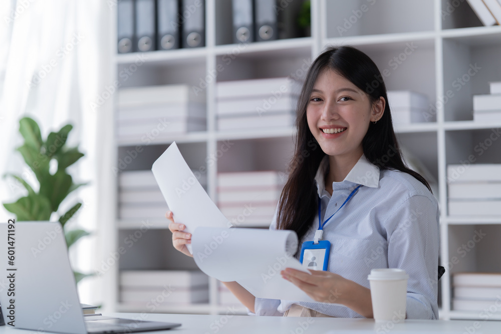 Smiling of business women holding coffee cup working in the office. Smiling of business women holding coffee cup working in the office.