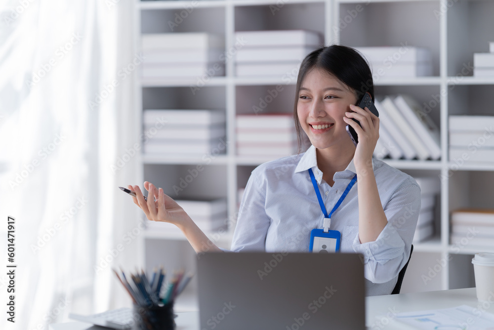Smiling of business women holding coffee cup working in the office. Smiling of business women holding coffee cup working in the office.