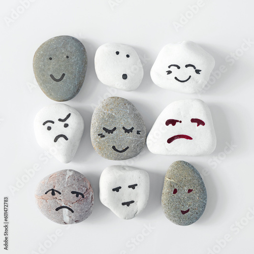 Emotion management concept  stones with painted faces symbolize different emotions. HRM or Human Resource Management. Learning to manage emotions. One team called humanity.