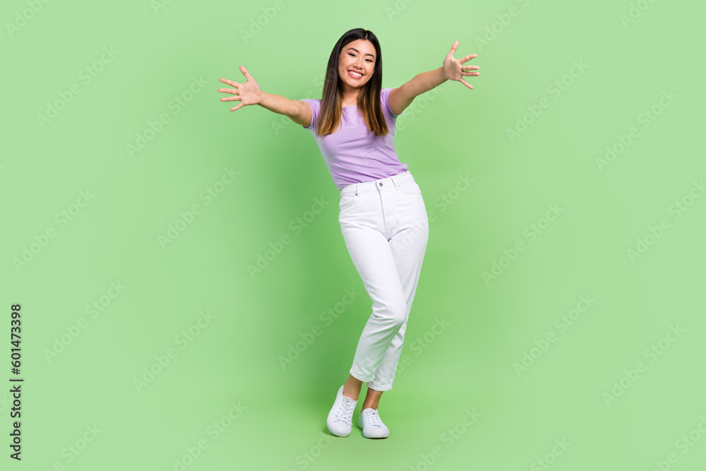 Full length body photo of young japanese girl hugs embracing you friendly wait welcome greetings isolated on green color background Full length body photo of young japanese girl hugs embracing you friendly wait welcome greetings isolated on green color background