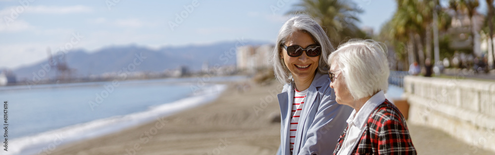 Happy female friends meeting outdoors by sea Happy female friends meeting outdoors by sea
