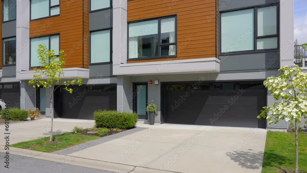 Establishing shot of modern apartment building with beautiful spring blossom landscape in Vancouver, Canada, North America. Day time on April 2023. ProRes 422 HQ. Establishing shot of modern apartment building with beautiful spring blossom landscape in Vancouver, Canada, North America. Day time on April 2023. ProRes 422 HQ.