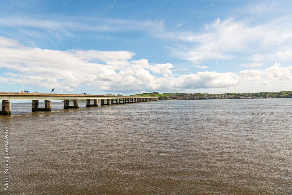 road bridge over the river tay from dundee to fife in scotland shot on a sunny spring day with fluffy white clouds and blue sky