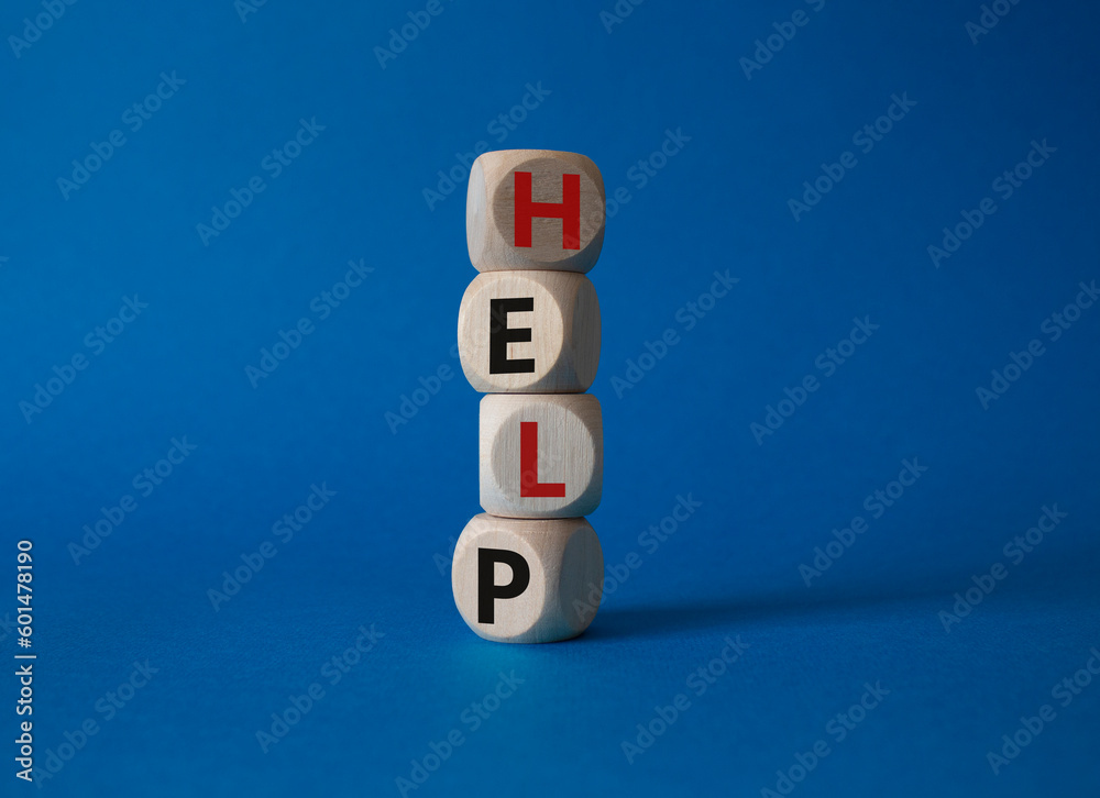 Help symbol. Concept word help on wooden cubes. Beautiful blue background. Business and help concept. Copy space. Help symbol. Concept word help on wooden cubes. Beautiful blue background. Business and help concept. Copy space.