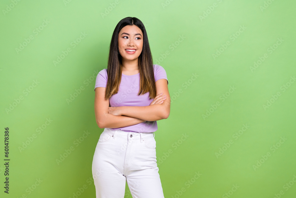 Photo of attractive japanese korean young woman crossed arms look empty space wear trendy purple clothes isolated on green color background Photo of attractive japanese korean young woman crossed arms look empty space wear trendy purple clothes isolated on green color background