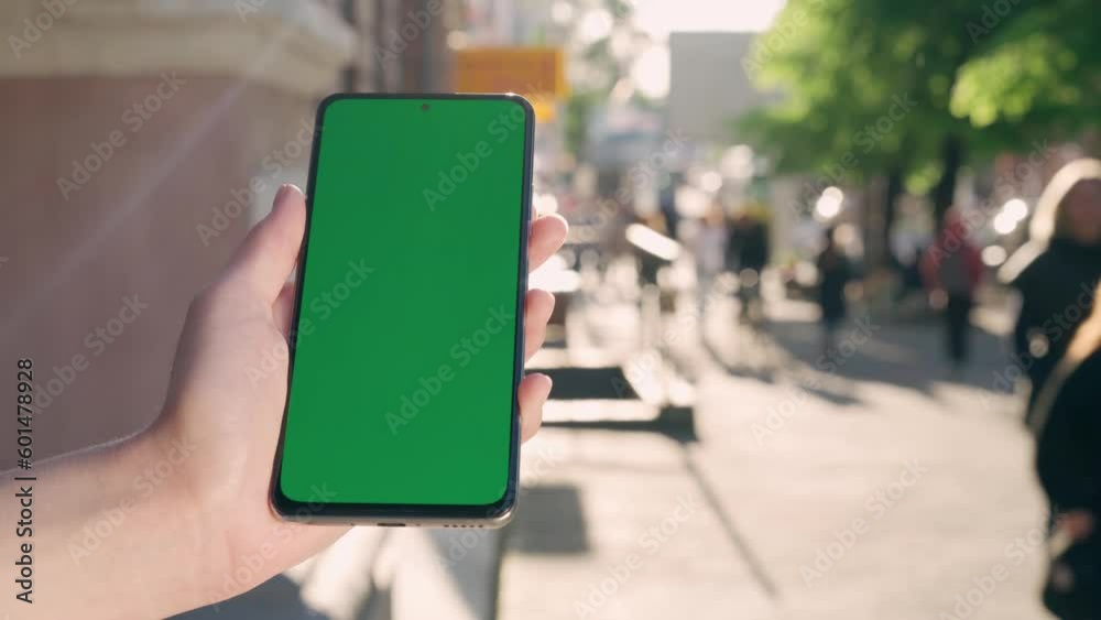 custom made wallpaper toronto digitalFemale Hand Holding Green Mock-up Screen Phone.Background Lively City Street
