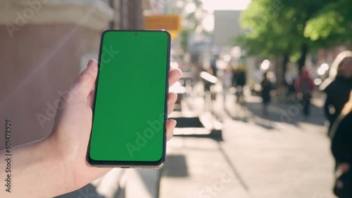 Wallpaper Mural Female Hand Holding Green Mock-up Screen Phone.Background Lively City Street Torontodigital.ca