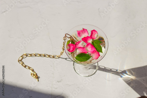 Fototapeta Naklejka Na Ścianę i Meble -  Rose petals in a martini glass, concept of beauty, style and fashion.