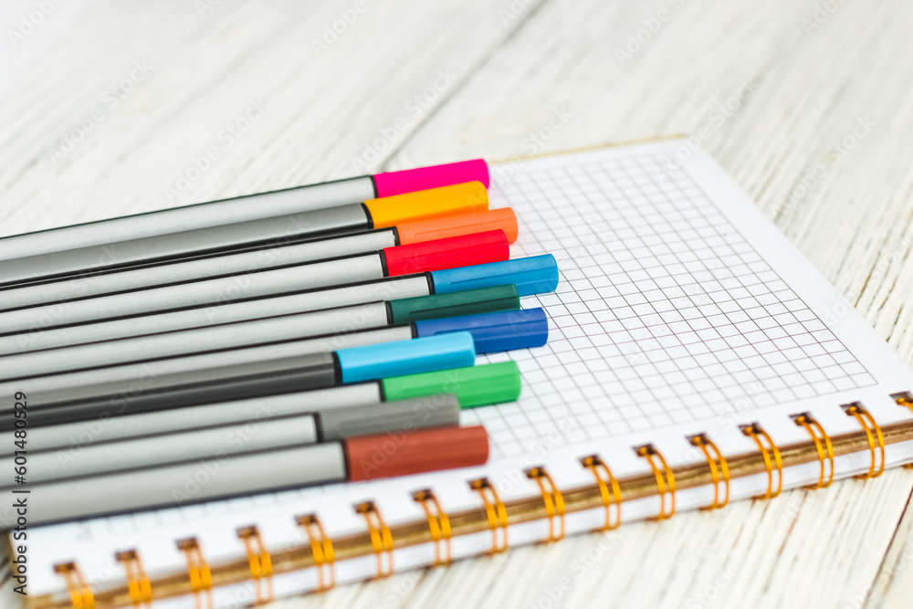 Fototapeta premium Notebook diary for planning and studying on the table with colored markers.