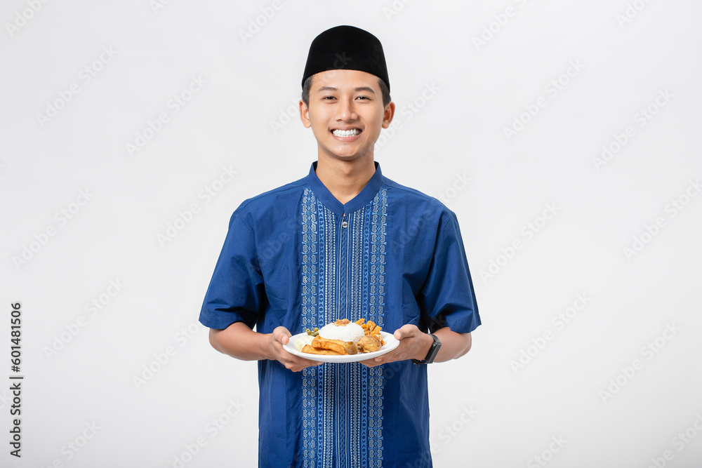 Young muslim man volunteer holding and sharing food for other person isolated on white background. Concept of alms, food sharing and help each other. Young muslim man volunteer holding and sharing food for other person isolated on white background. Concept of alms, food sharing and help each other.