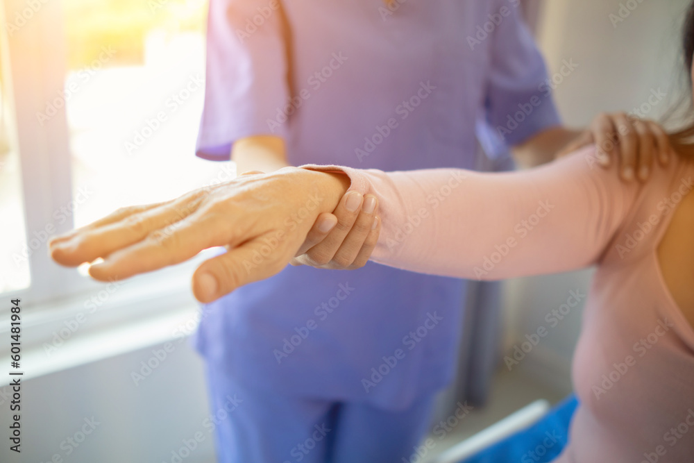 Fototapeta premium Physical therapists are helping elderly people to take care of themselves after a long period of recovery and they need regular physical therapy to help their bodies recover. physical therapy concept