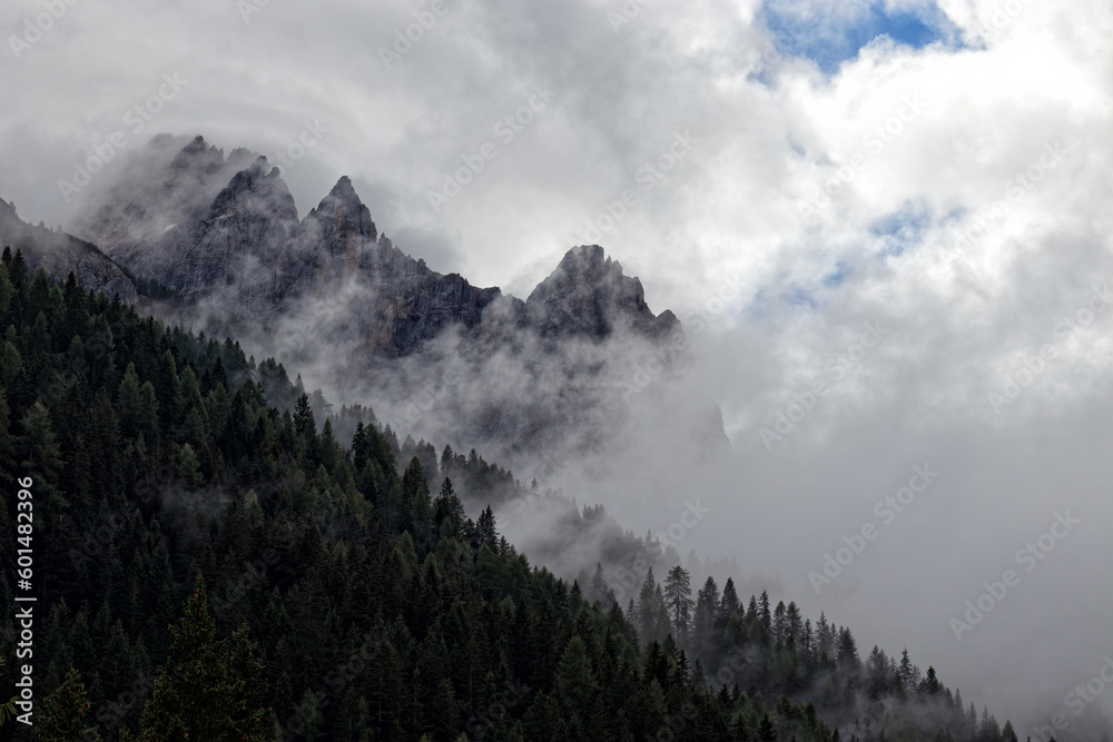 View of the peaks of the Sesto Dolomites through clouds and fog, Alps, South Tyrol, Italy, Europe