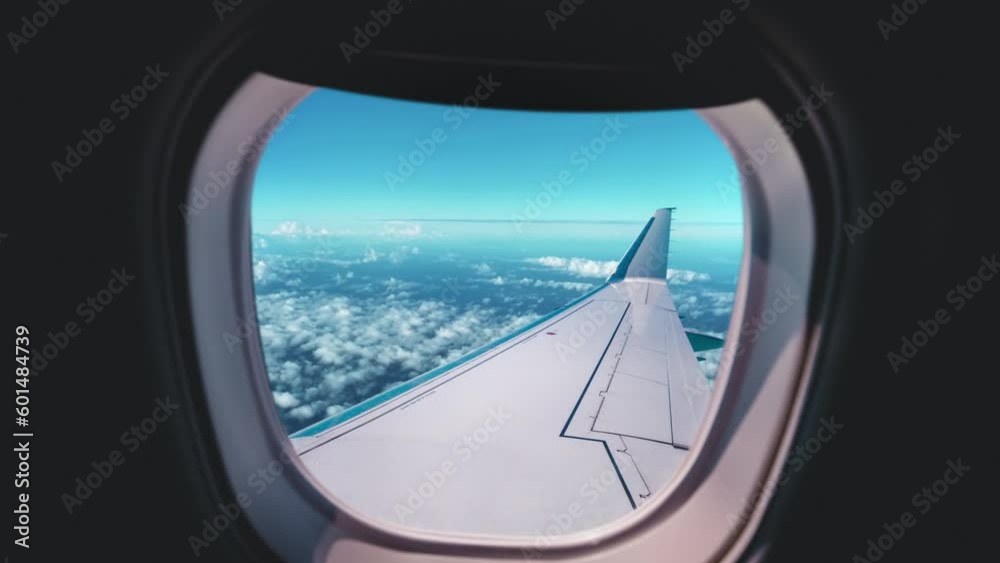 Beautiful view of cloud and wing of airplane from window with a nice blue sky Beautiful view of cloud and wing of airplane from window with a nice blue sky