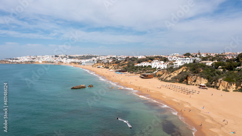 Aerial photo of the beautiful town in Albufeira in Portugal showing the Praia de Albufeira golden sandy beach, with hotels and apartments in the town, taken on a summers day in the summer time. © Duncan
