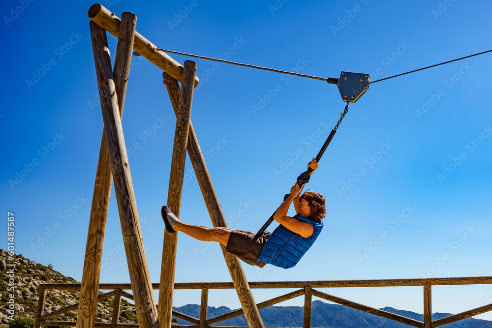 Adult woman having fun on zipline