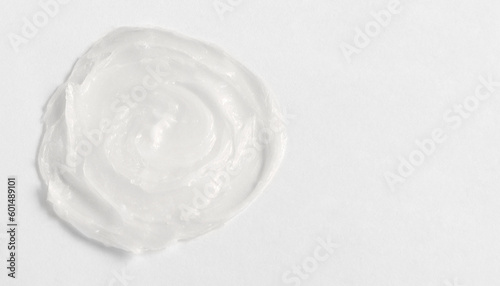 The texture of the lip balm. Transparent ointment on a white background and copy space photo