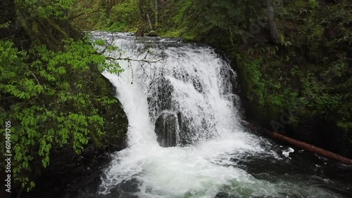 A waterfall in slow-motion surrounded by green moss