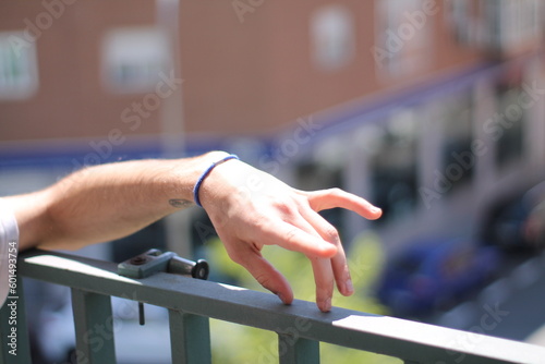 Exploring Tactile Sensations: Close-up of Hand on Railing Engaging in Finger Play