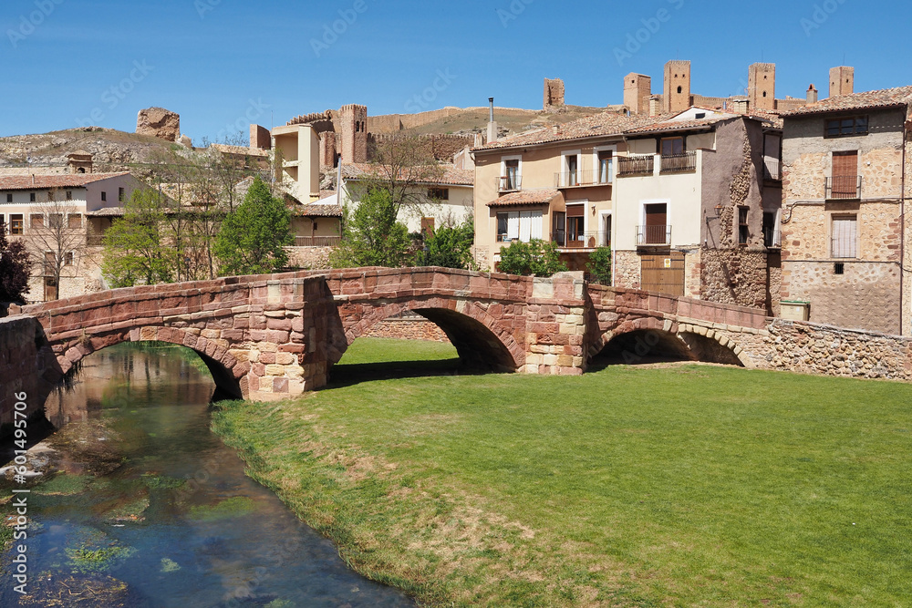 beautiful view of the roman bridge of molina de aragon with its castle in the background