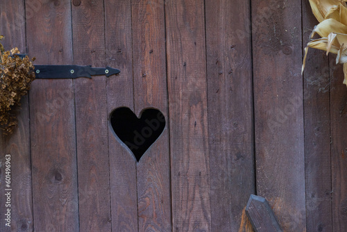 Foto heart shape on a wooden door, WC sign