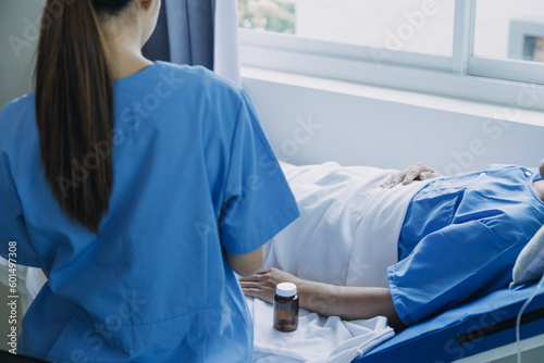 Terminally Ill Male Patient Lies on a Bad In the Hospital. Melancholy and Exhausted Patient in the Palliative Care Ward. photo