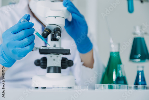 hand of scientist with test tube and flask in medical chemistry lab blue banner background