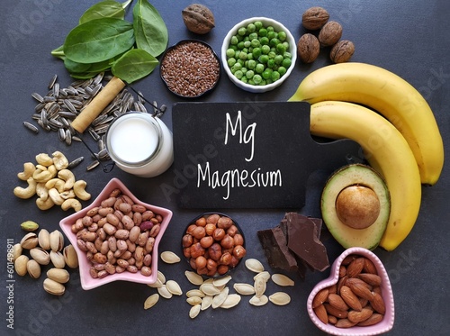 Magnesium rich foods. Natural food sources of magnesium. Assortment of fresh fruit, vegetable, nuts and seeds high in magnesium. Banana, nuts, seeds, beans, avocado, milk, dark chocolate, spinach, etc