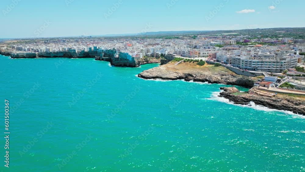 Aerial view of Polignano a Mare in Puglia, Italy with rocky seashore houses. Beautiful view of the entire Town with whitewashed and colourful houses by the cliffside turquoise Adriatic sea in Europe Aerial view of Polignano a Mare in Puglia, Italy with rocky seashore houses. Beautiful view of the entire Town with whitewashed and colourful houses by the cliffside turquoise Adriatic sea in Europe