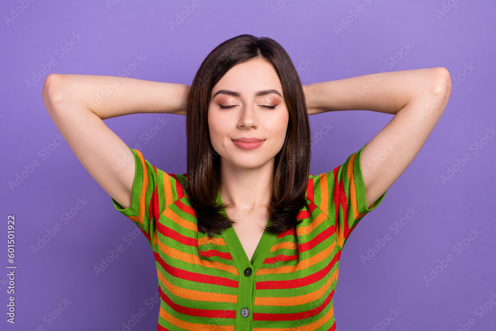 Portrait of cute good mood girl dressed striped cardigan holding arms behind head sleeping eyes closed isolated on violet background Portrait of cute good mood girl dressed striped cardigan holding arms behind head sleeping eyes closed isolated on violet background