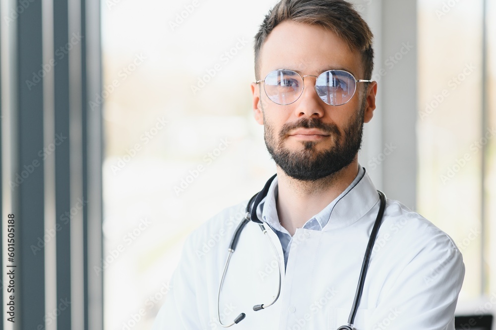 Portrait of young male doctor with stethoscope, close up Portrait of young male doctor with stethoscope, close up
