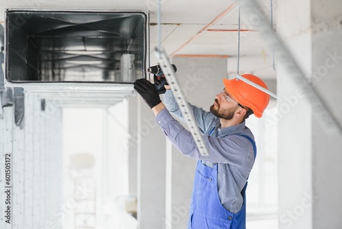 hvac engineer install heat recovery ventilation system for new house. copy space photo