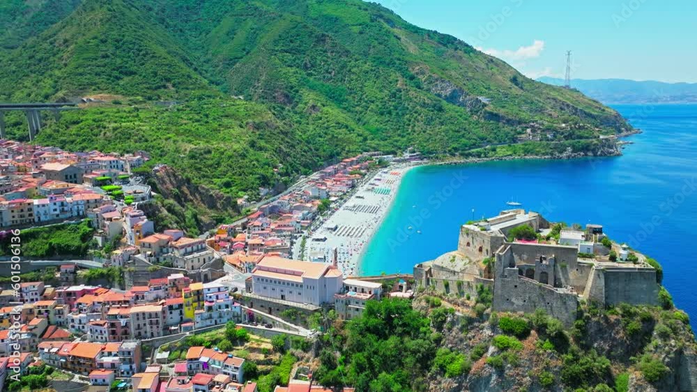 Aerial view of touristic blue lagoon beach with people relaxing in Calabria. Drone view of a beach with an incredibly blue sea and boats in the south of Italy on a summer sunny day. Aerial view of touristic blue lagoon beach with people relaxing in Calabria. Drone view of a beach with an incredibly blue sea and boats in the south of Italy on a summer sunny day.
