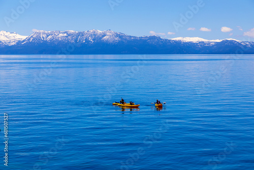People in Kayaks on Lake Tahoe on the East side near Incline Village, Nevada with view of Northwest side of Lake Tahoe California across the lake towards Granite Chief Wilderness