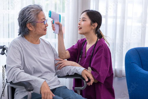 Caregiver nurse take care a Senior patient walking in park. Nurse helping senior Woman