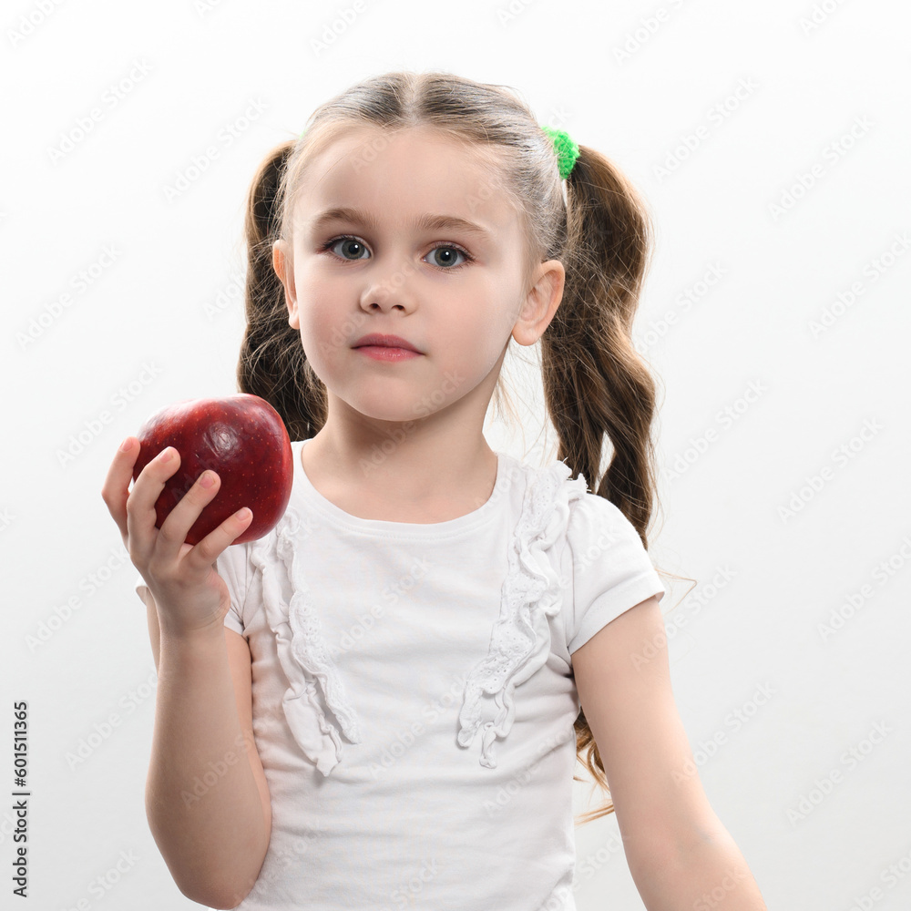 Red apple and little girl, portrait of a child on a white background Red apple and little girl, portrait of a child on a white background