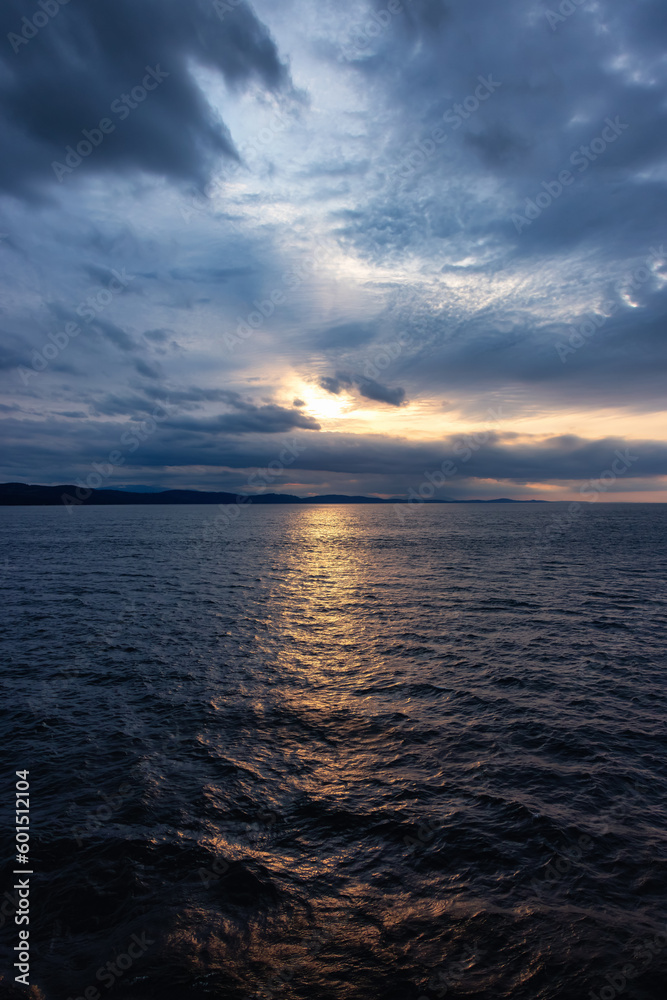 Cloudy Cloudscape during stormy everning on the West Coast of Pacific Ocean. British Columbia, Canada. Sunset Sky