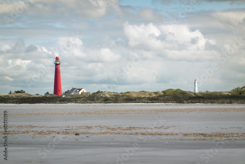 View over mudflat on beach, dunes and two lighthouse of Dutch island Schiermonnikoog photo