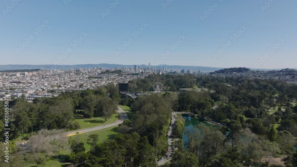 Forwards fly above large urban park in metropolis. Golden Gate Park with trees, lawn, lake, museums and attractions. San Francisco, California, USA Forwards fly above large urban park in metropolis. Golden Gate Park with trees, lawn, lake, museums and attractions. San Francisco, California, USA