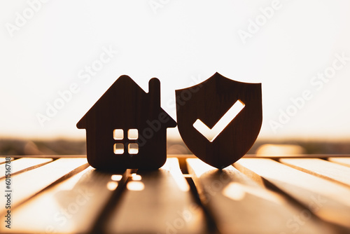 Slika na platnu Silhouette of  Wooden house model and real estate insurance ideas, and small shield icon