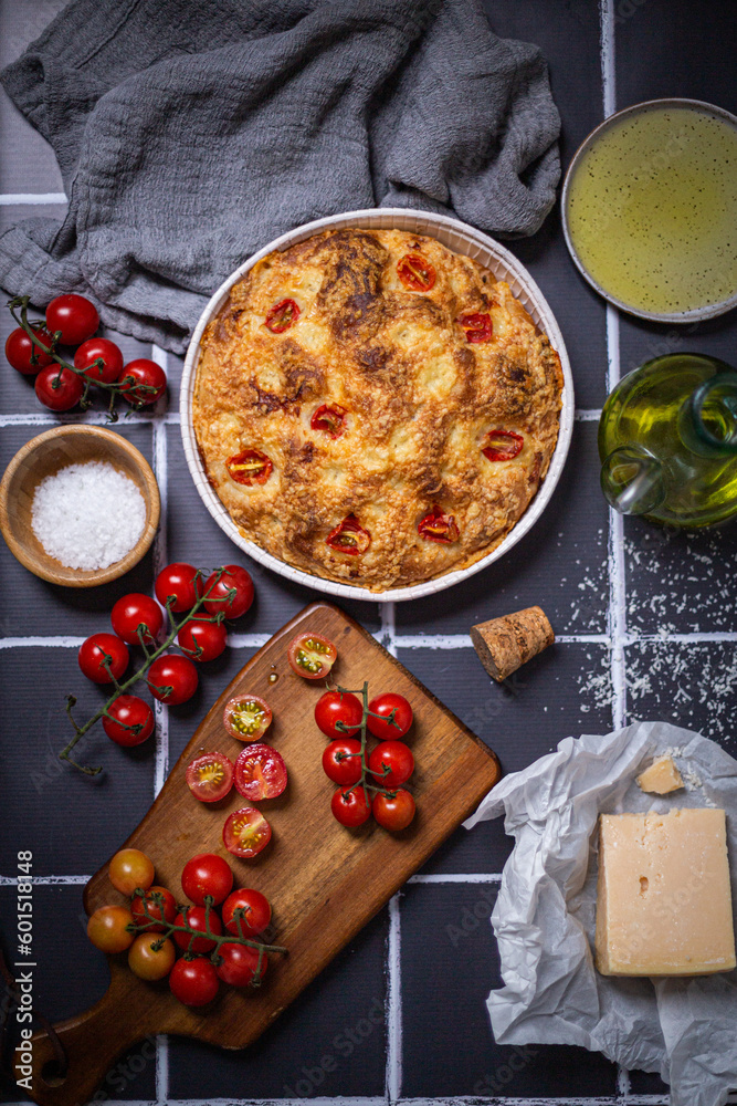 Focaccia with parmesan cheese and sweet grape tomatoes with raw tomatoes grated parmesan cheese and olive oil. Focaccia with parmesan cheese and sweet grape tomatoes with raw tomatoes grated parmesan cheese and olive oil.
