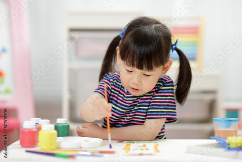 young girl water color painting for homeschooling