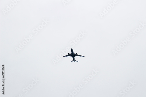 Fototapeta Naklejka Na Ścianę i Meble -  Passenger plane taking off in the dark cloudy sky