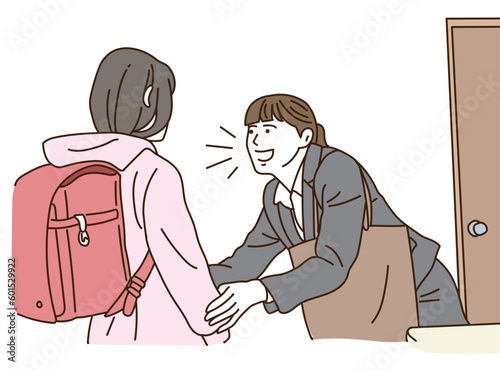 小学生の子供の頭を撫でるスーツ姿の母親
