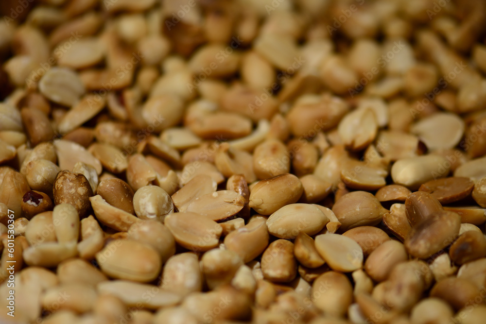 Roasted peanuts close-up, top view. Selective sharpness. Roasted peanut kernels. The texture of peeled peanuts. Hypogee peanuts, peeled from the shell. Crispy snack Roasted peanuts close-up, top view. Selective sharpness. Roasted peanut kernels. The texture of peeled peanuts. Hypogee peanuts, peeled from the shell. Crispy snack