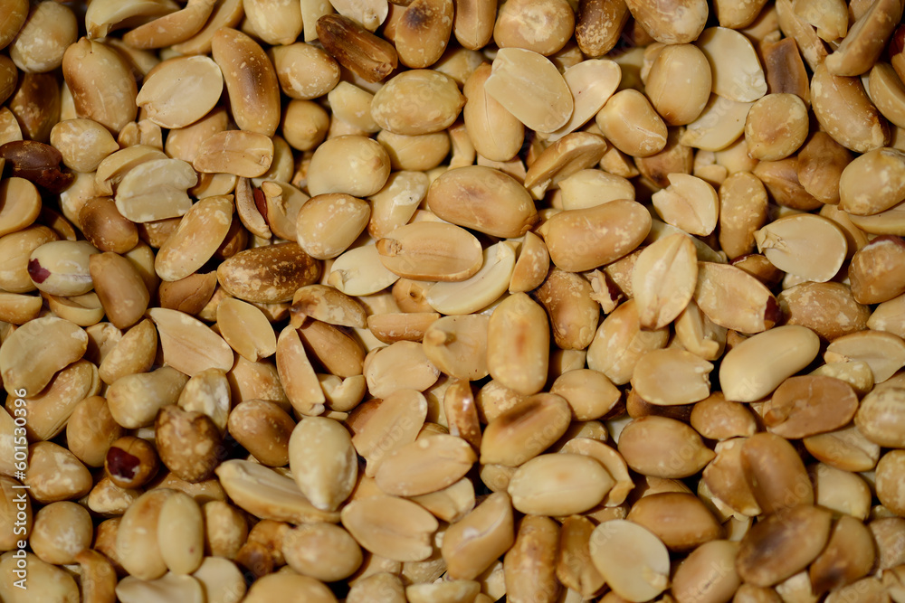 Roasted peanuts close-up, top view. Selective sharpness. Roasted peanut kernels. The texture of peeled peanuts. Hypogee peanuts, peeled from the shell. Crispy snack Roasted peanuts close-up, top view. Selective sharpness. Roasted peanut kernels. The texture of peeled peanuts. Hypogee peanuts, peeled from the shell. Crispy snack