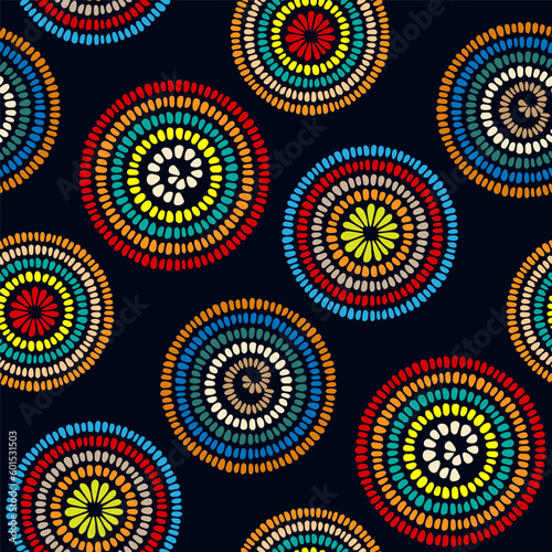 Bright multicolored colorful circles isolated on a dark blue background. Cute geometric floral seamless pattern. Vector simple flat graphic illustration. Texture.