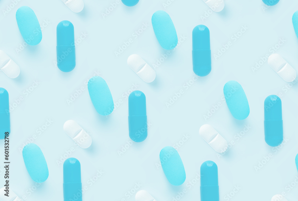 pattern of pills on a blue background. Many pills on a light background pattern of pills on a blue background. Many pills on a light background