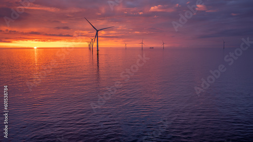 Sunset offshore at wind turbine farm