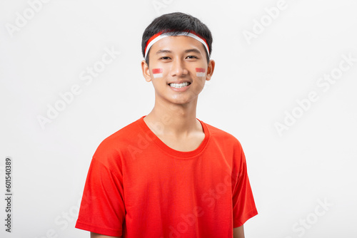 Young Indonesian man very happy and excited celebrate Indonesia independence day 17 August isolated on white background. Dirgahayu 78 Tahun Kemerdekaan Indonesia.